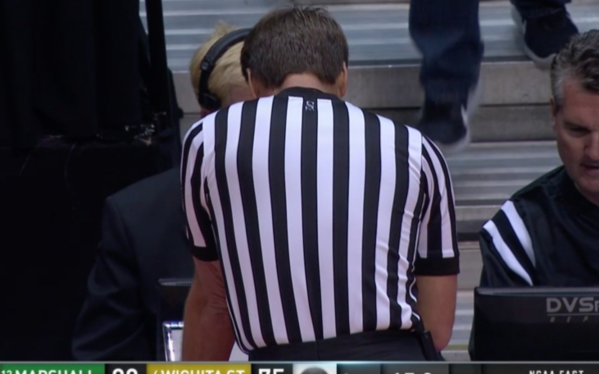Ref stares at monitor.