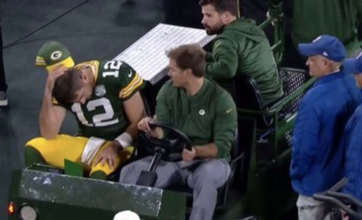 aaron rodgers is carted off the field with an injury