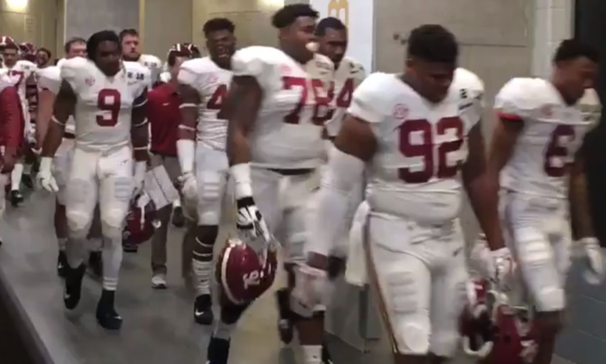 Alabama players walking into locker room.
