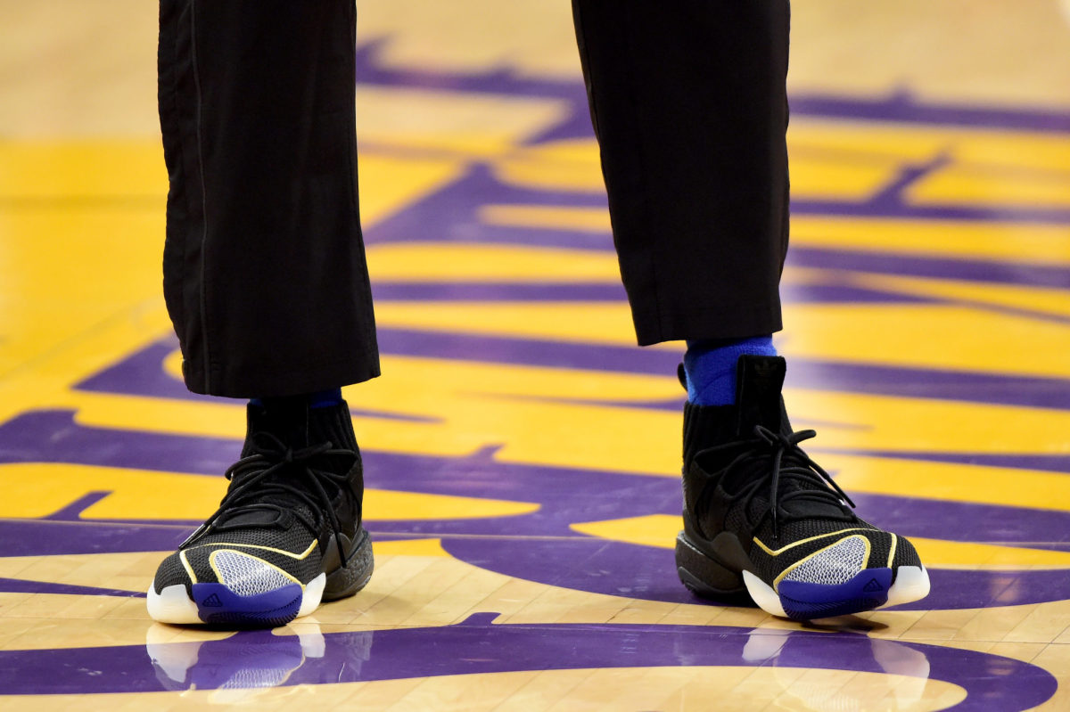 A picture of Kobe Bryant's sneakers at the center of the los angeles lakers court.