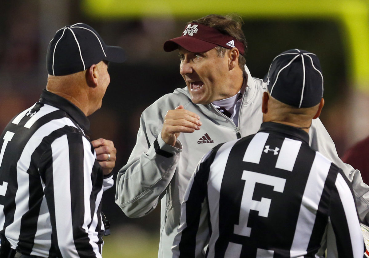 Dan Mullen talking to referees while wearing a Mississippi State hat