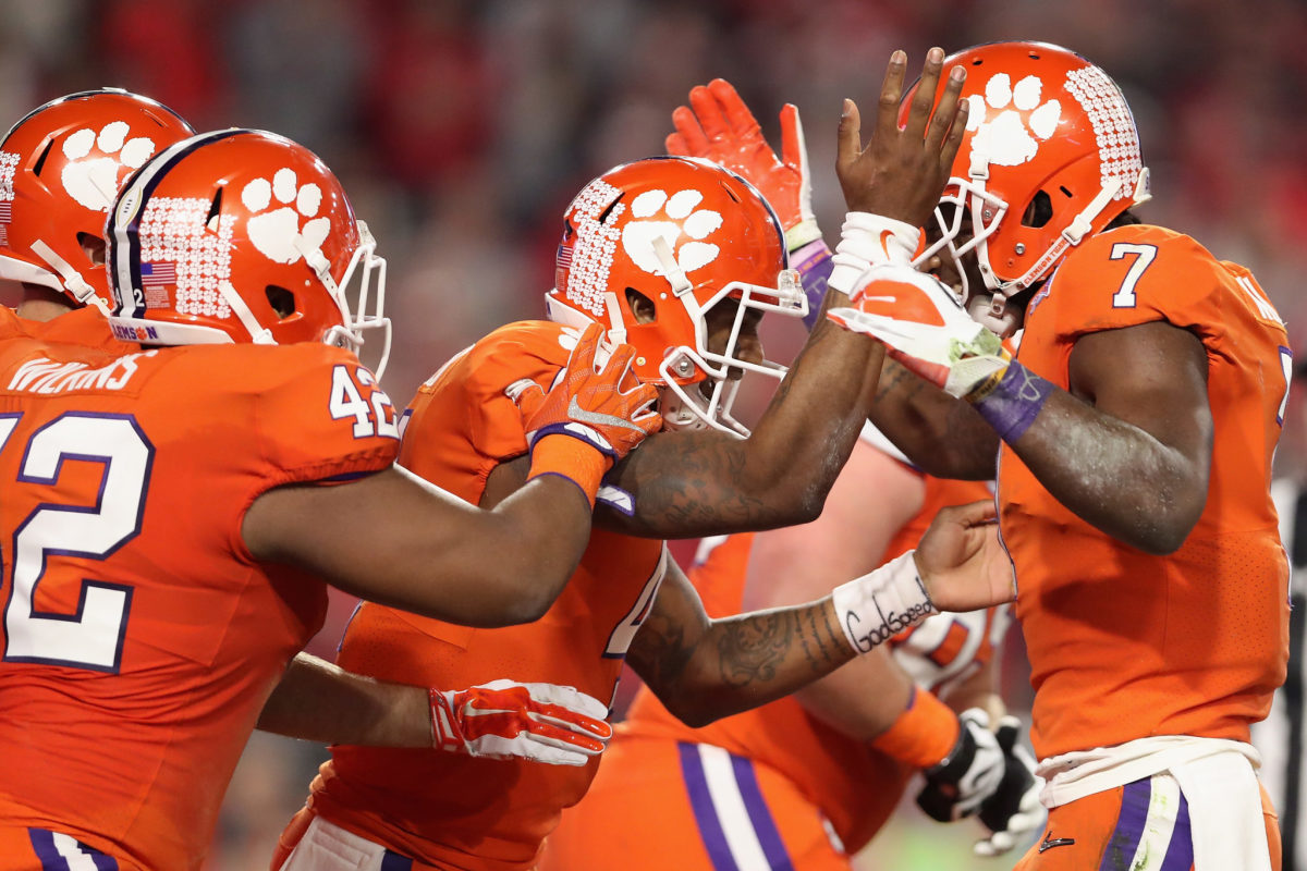 Clemson players celebrating with Deshaun Watson after a touchdown.