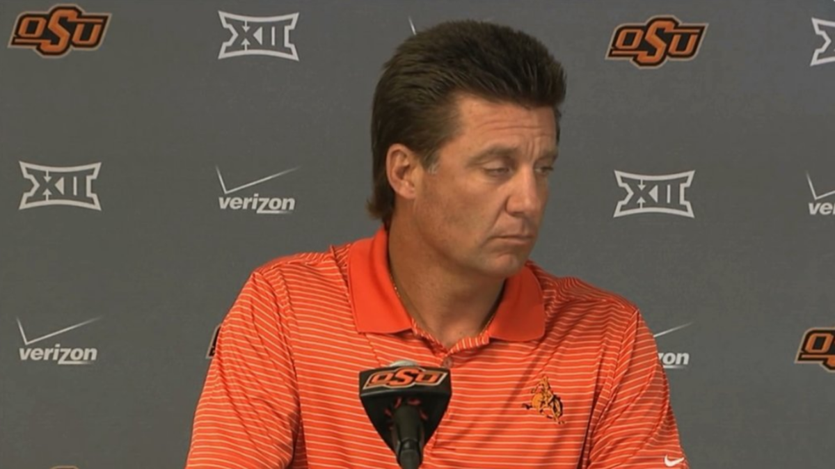 Mike Gundy speaking at a press conference.