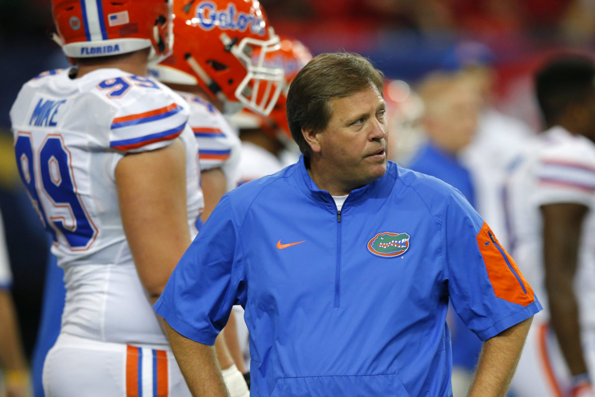 Coach Jim McElwain wearing a Florida Gators pullover on the sideline during a game.