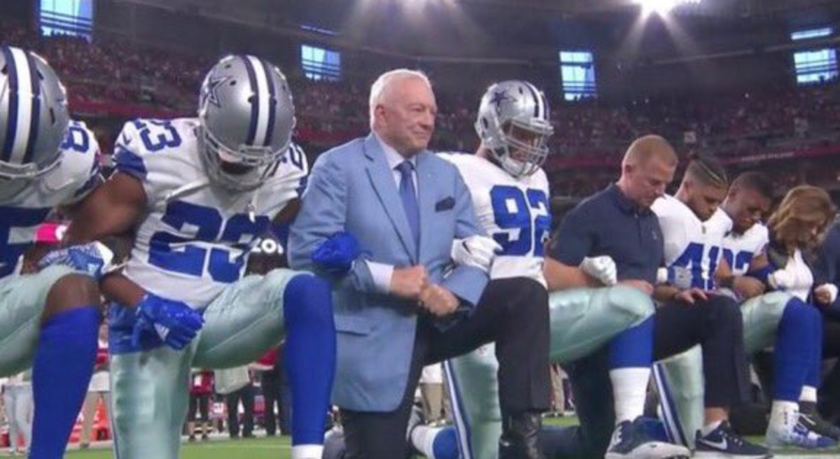 Jerry Jones kneels with Cowboys players.