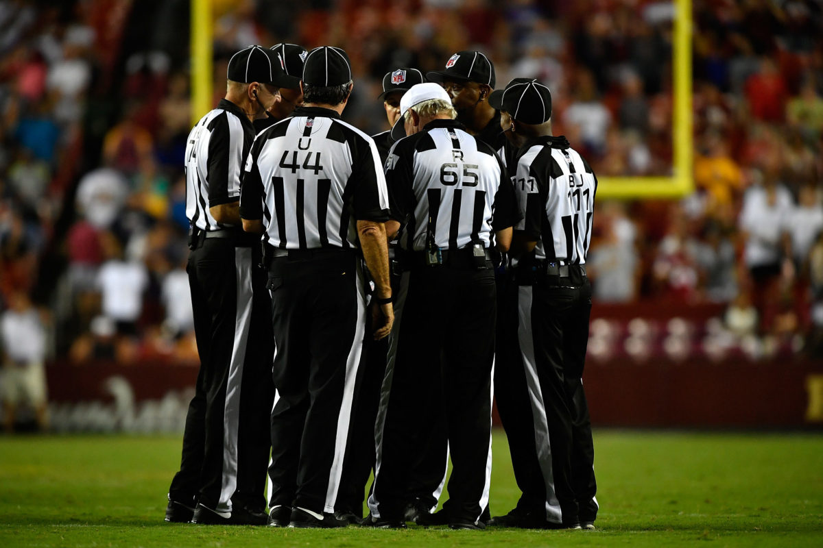 nfl referees talk during a game