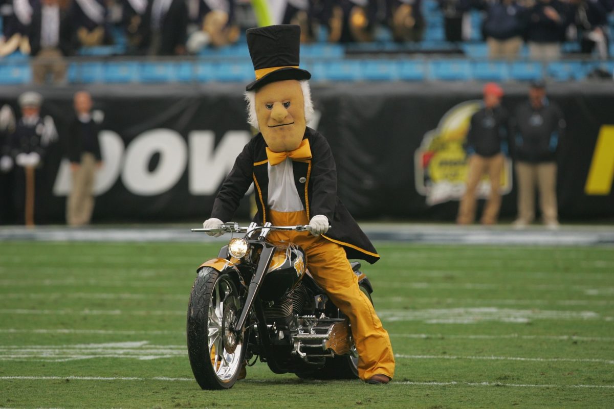 Wake Forest's mascot driving a motorcycle.