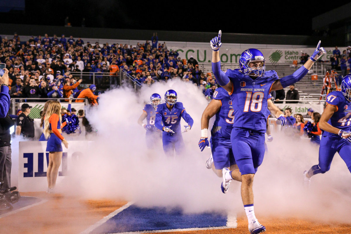 Boise State's football players running onto the field.