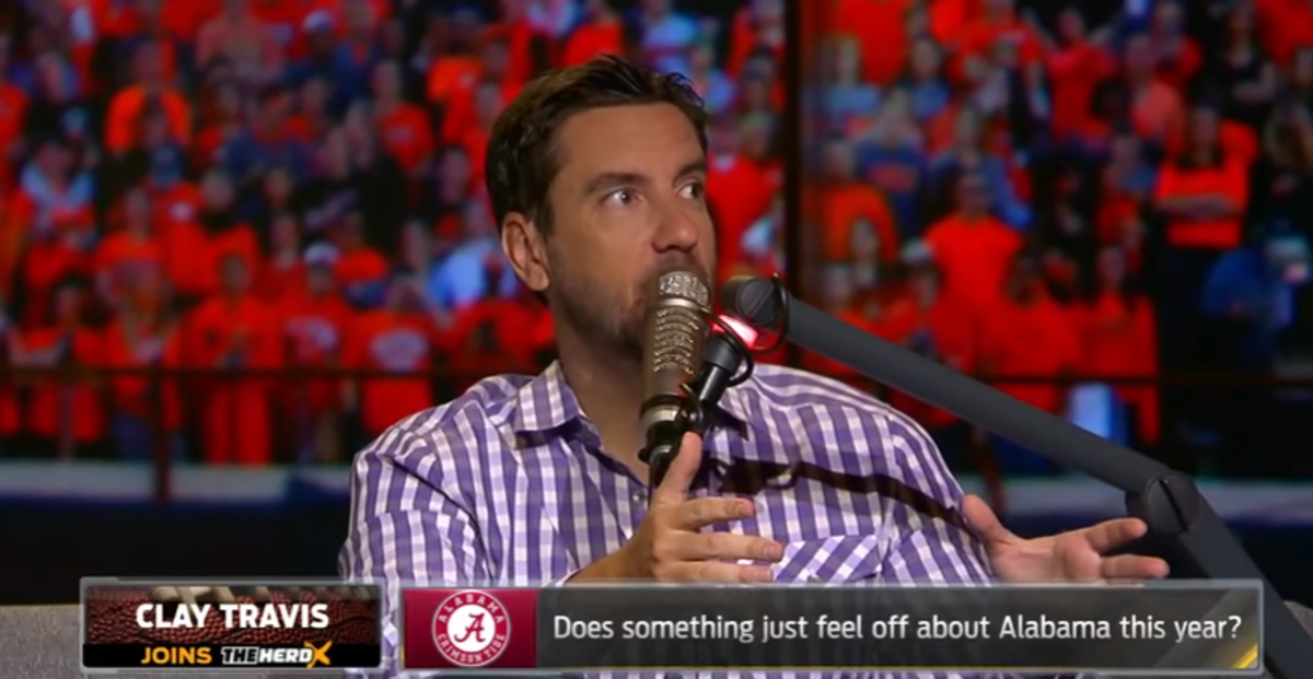 Clay Travis speaking into a microphone on The Herd.
