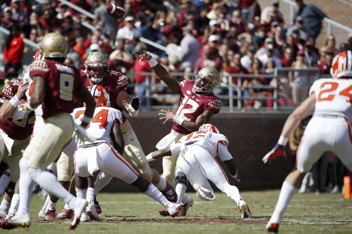 Deondre Francois being hit by a Clemson defender.