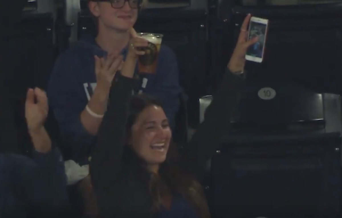 Girl catches foul ball with her beer.