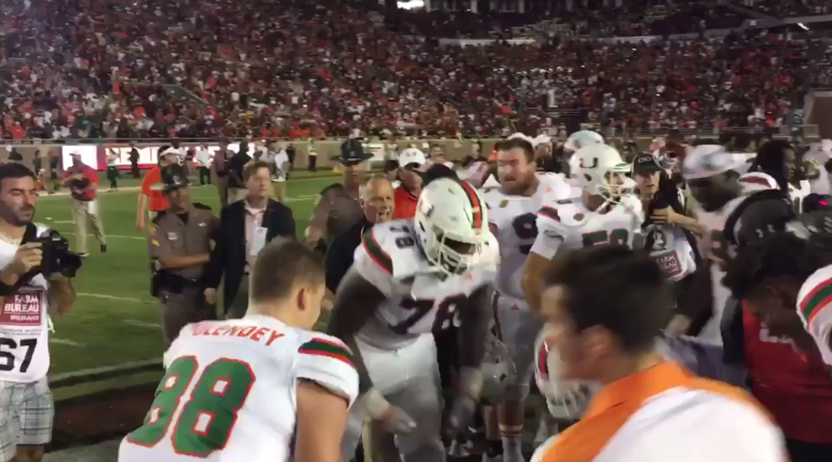 Mark Rich yells at his players to get off FSU logo.