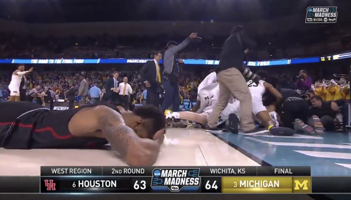 A Houston player lies on the floor after losing to Michigan.