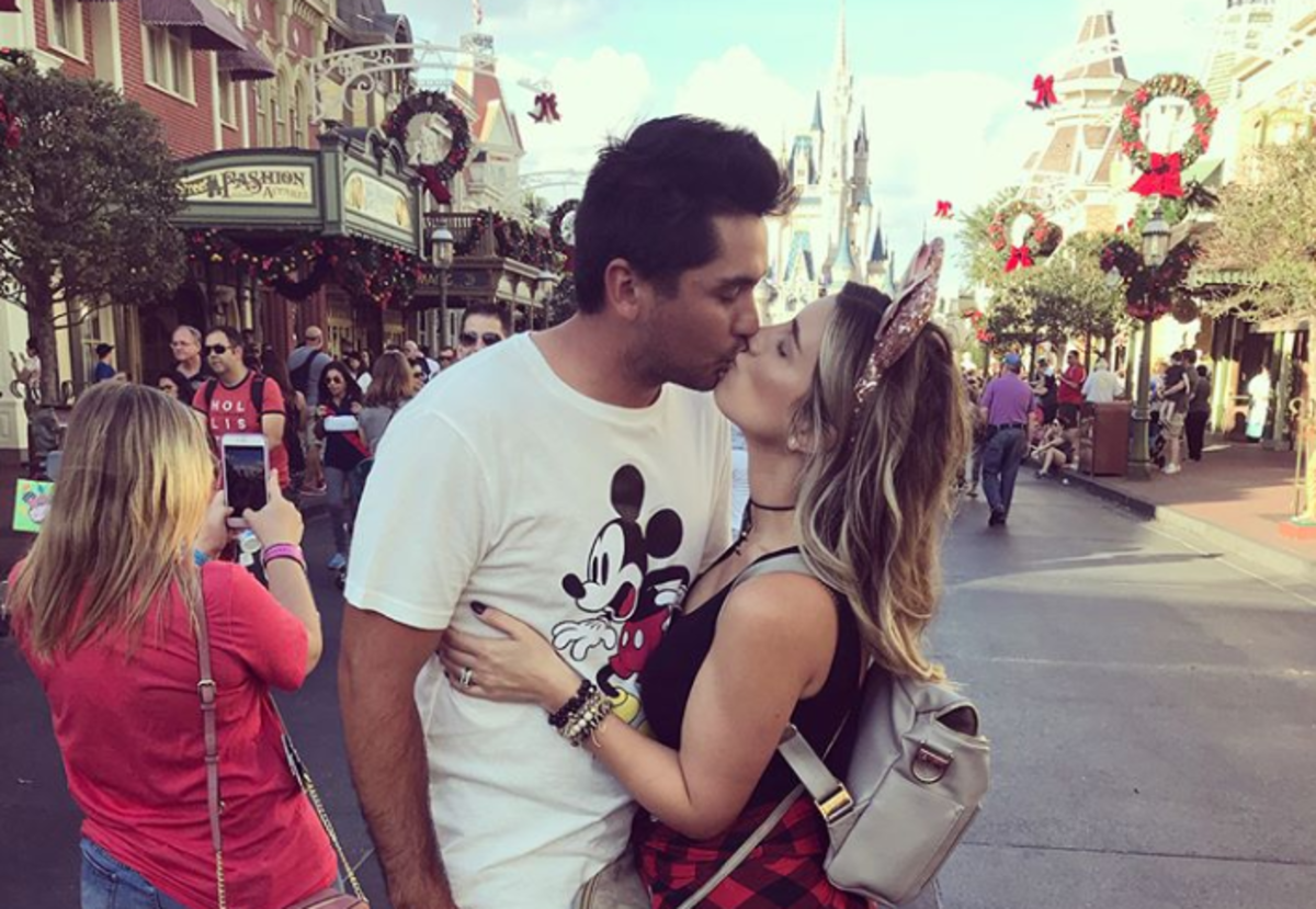 Jason Day and his wife Elle kissing.