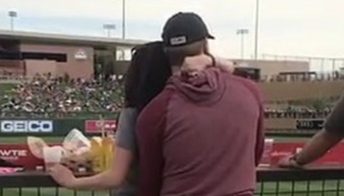 Fans engage in sexual activity during a spring training game.