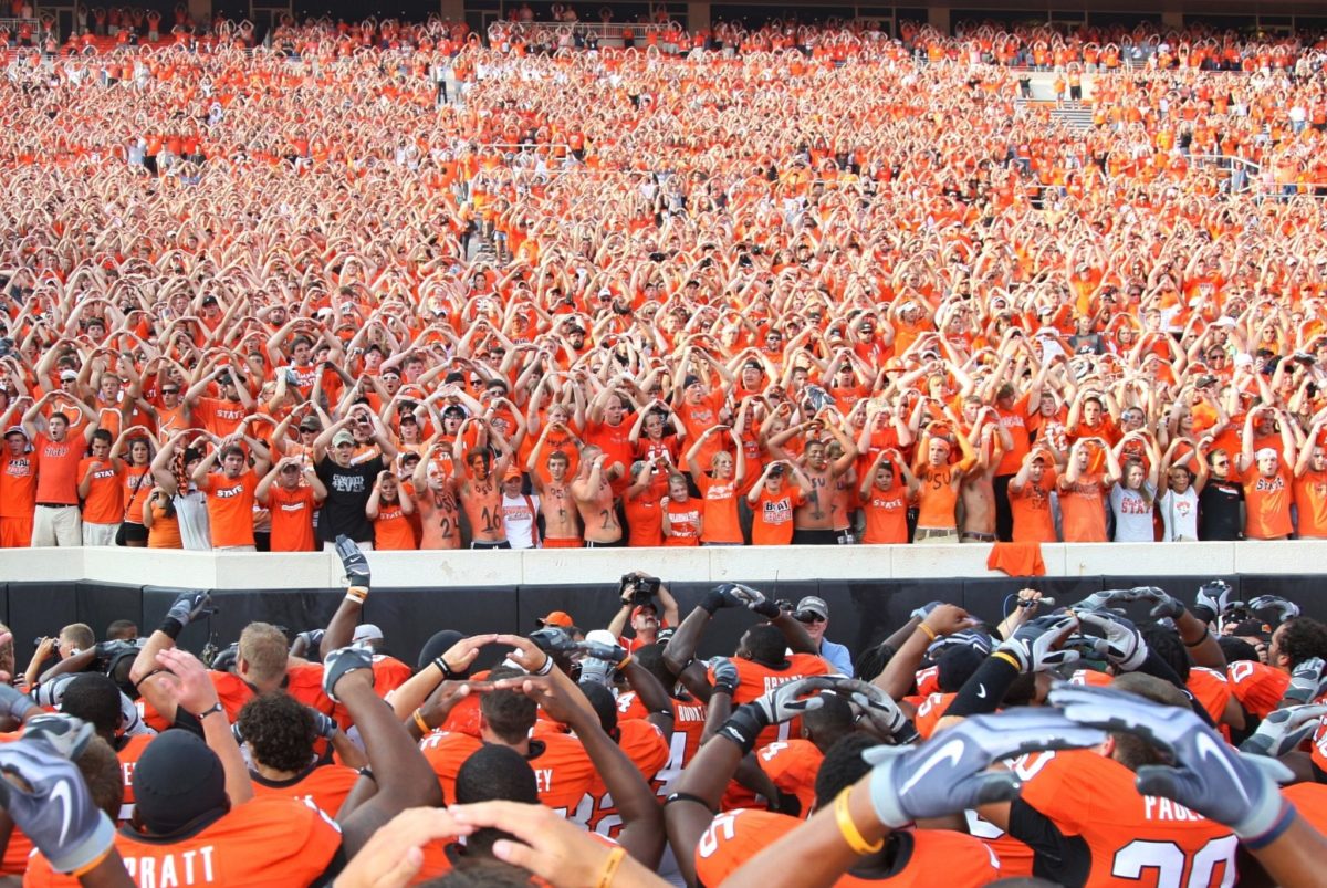 A picture of Oklahoma State players interacting with fans.