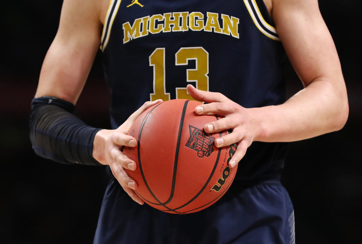 A closeup of Moe Wagner holding a basketball.