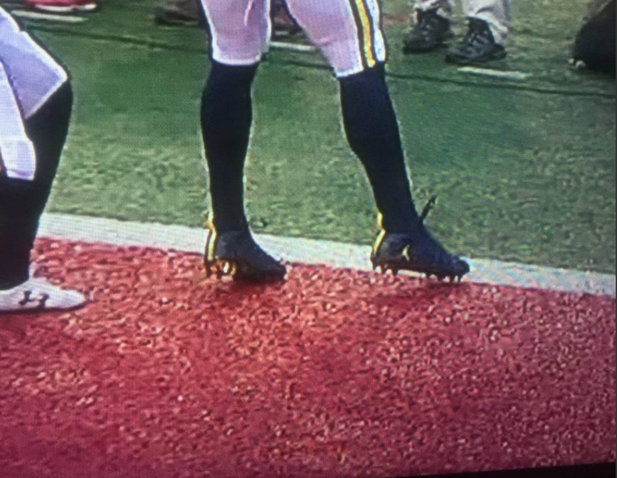 Michigan player attempts to get feet in bounds.