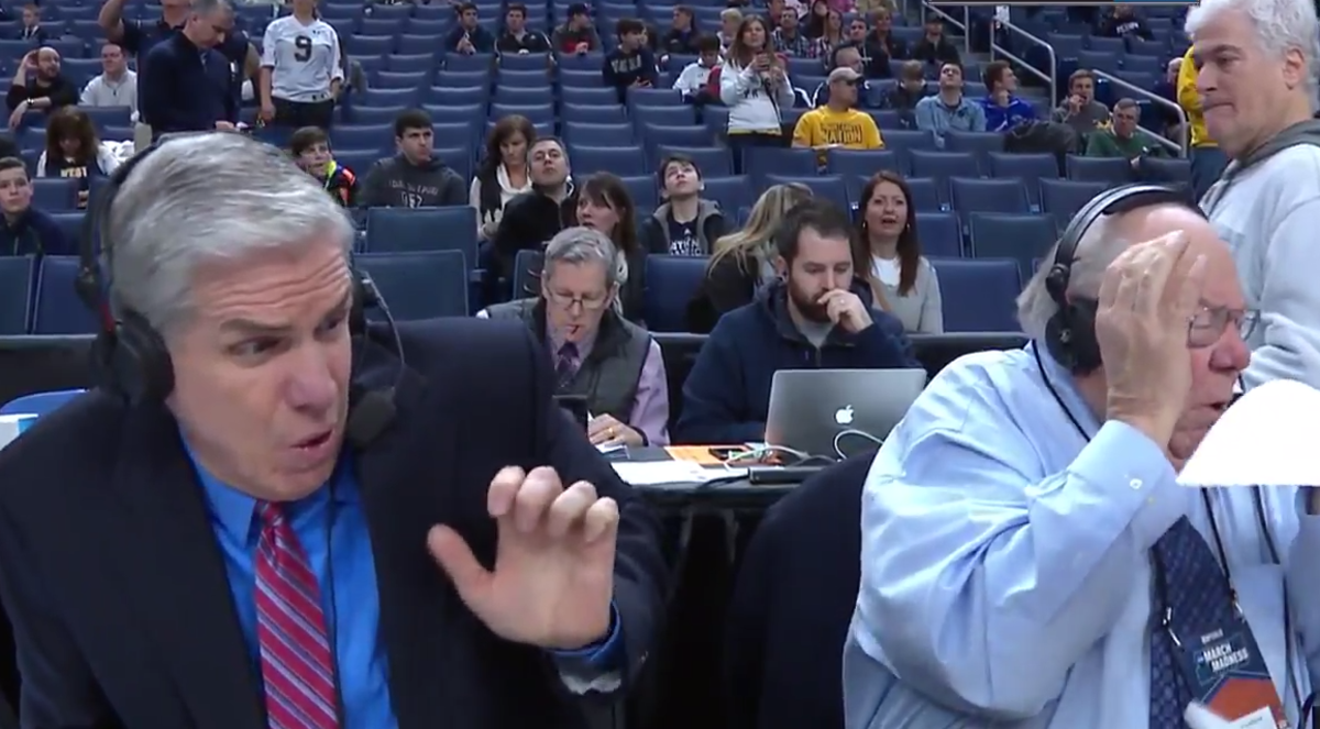Verne Lundquist reacts to getting hit in the face with a basketball.