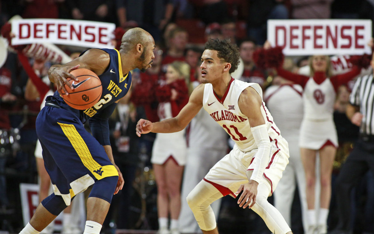 Trae Young guarding Jevon Carter in a game between Oklahoma and West Virginia.