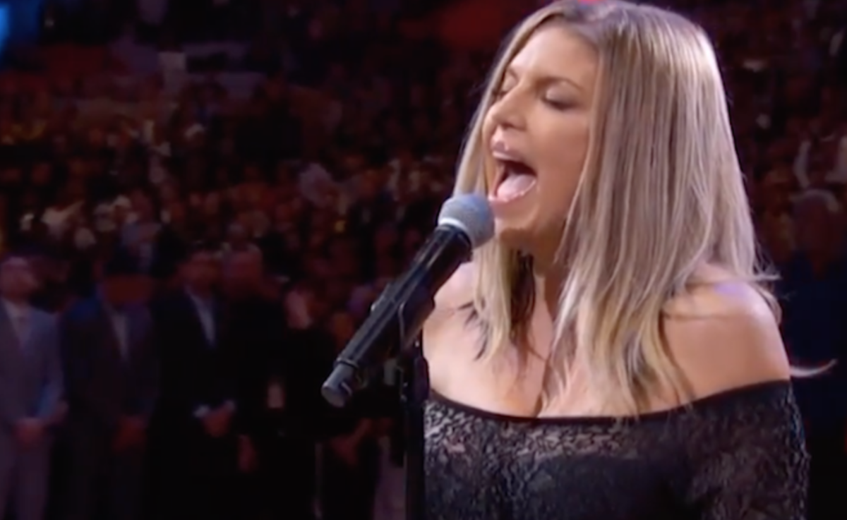 Fergie singing into a microphone.