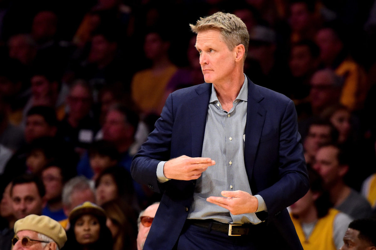 Steve Kerr coaching on the sidelines for the Golden State Warriors.