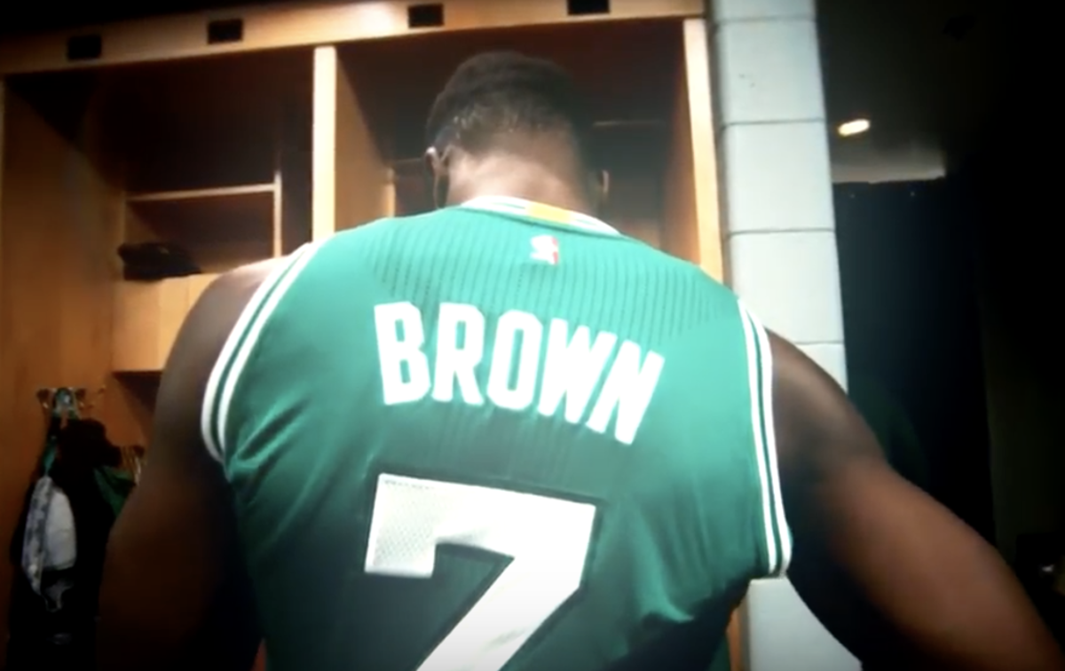 jaylen brown puts his celtics jersey on before a game