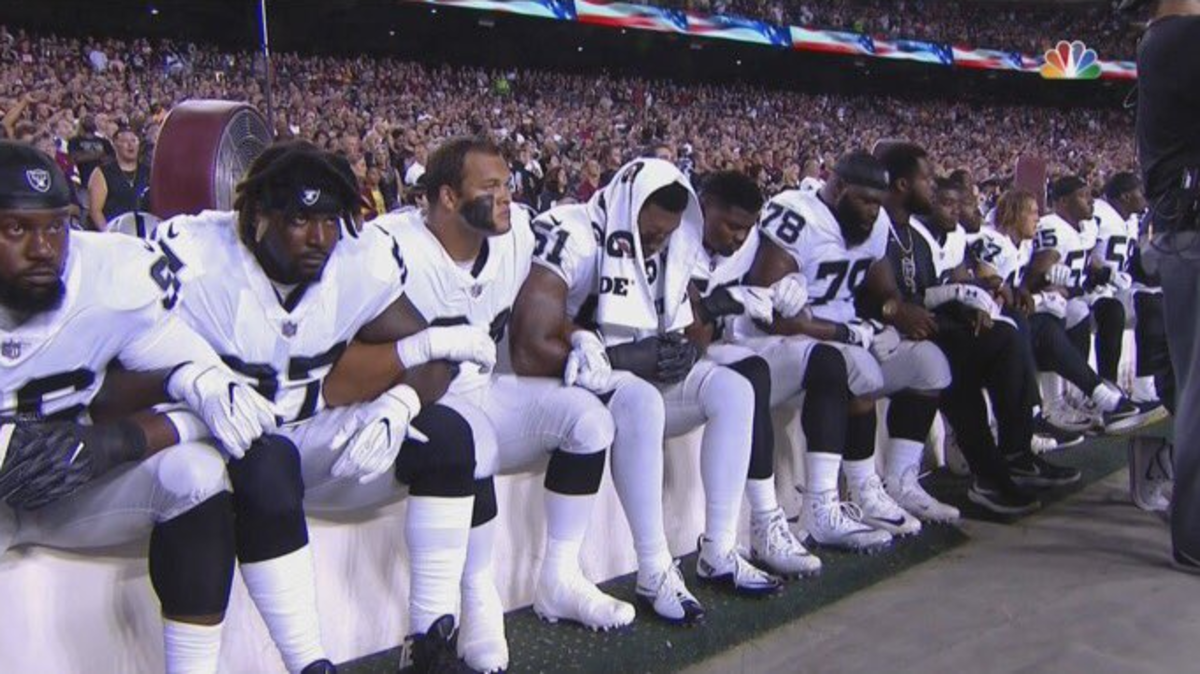 Oakland Raiders sit during national anthem.