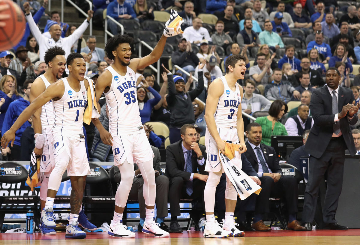 Grayson Allen, Marvin Bagley, and Tevon Duval celebrate on the sideline.