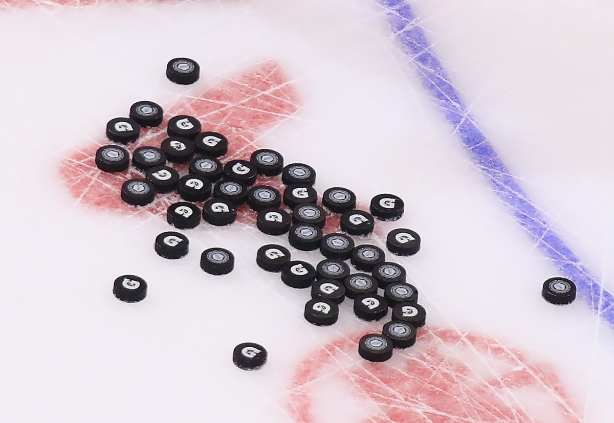 Numerous hockey pucks with the Gatorade logo on them.