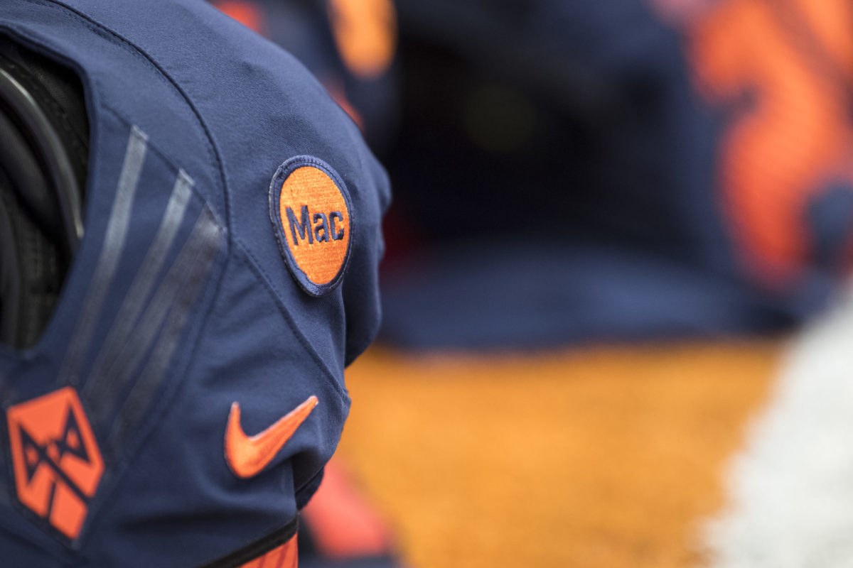 A closeup of a Syracuse Football uniform with a patch that says Mac.