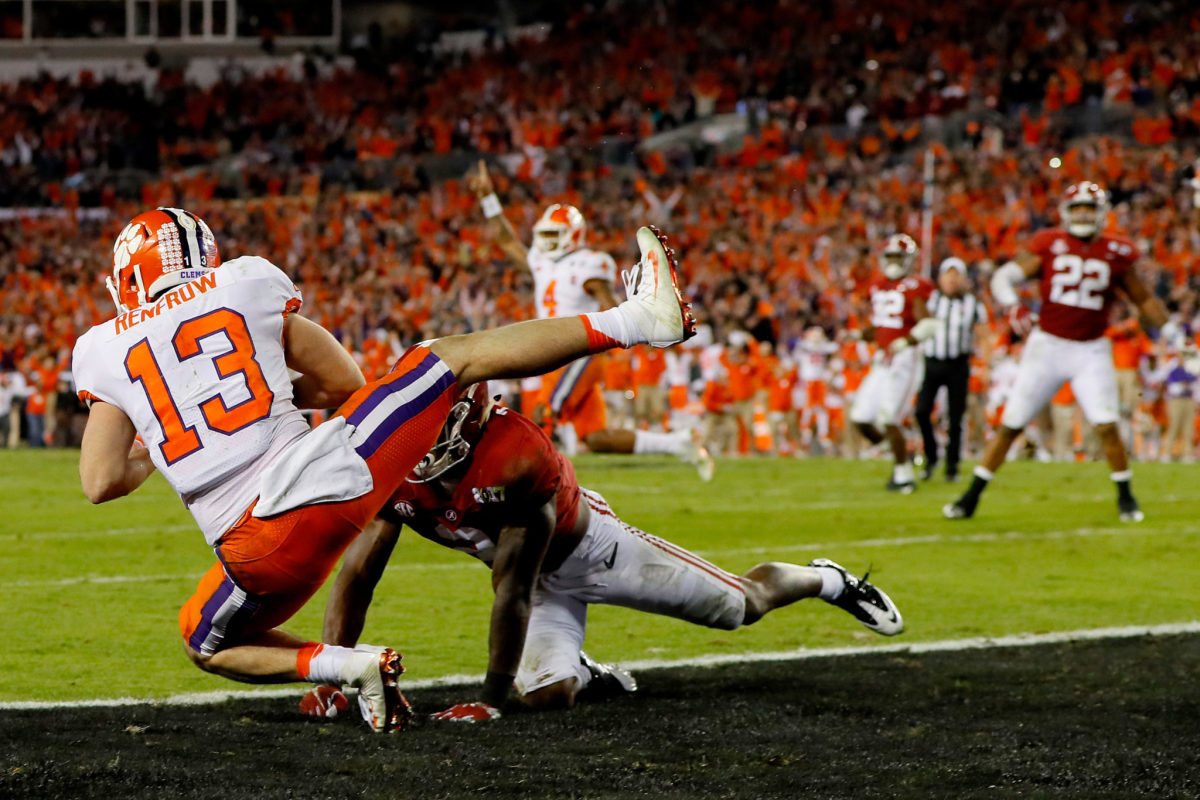 Wide receiver Hunter Renfrow #13 of the Clemson Tigers makes a 2-yard game-winning touchdown reception against defensive back Tony Brown #2 of the Alabama Crimson Tide.