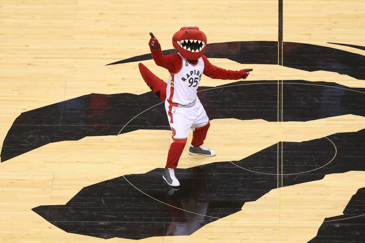 The Toronto Raptors mascot dancing at center court.