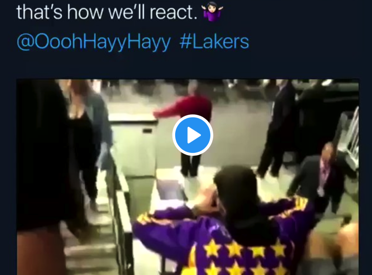 Woman throws drinks at Lakers fans.