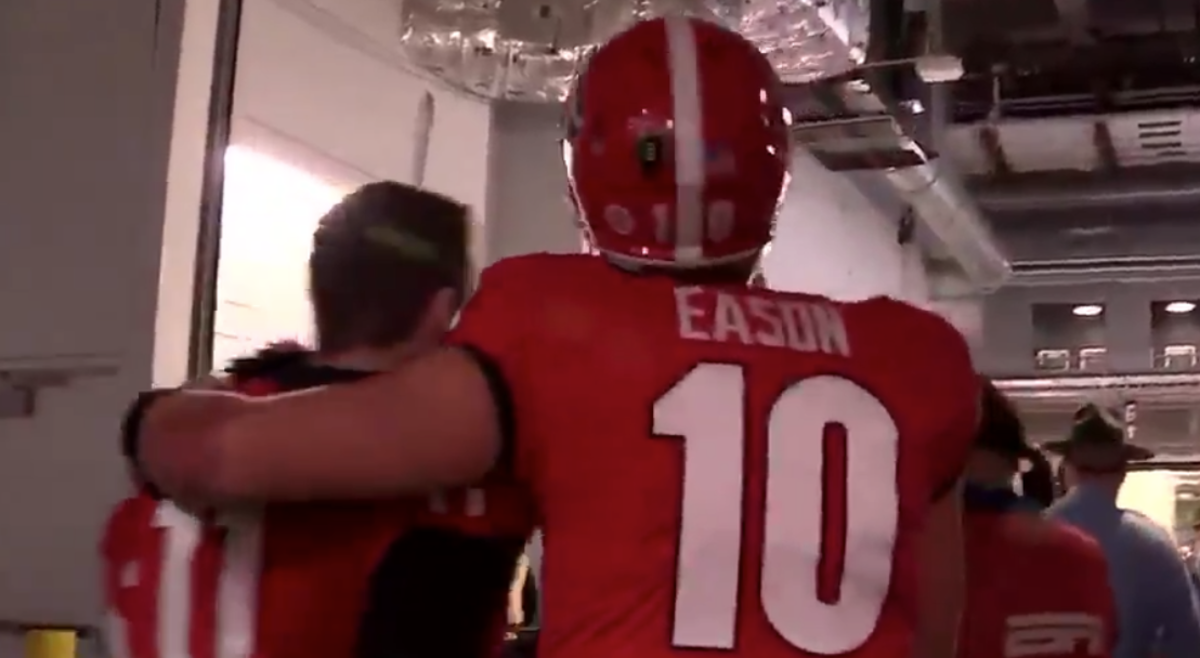 Jacob Eason with his arm around Jake Fromm.