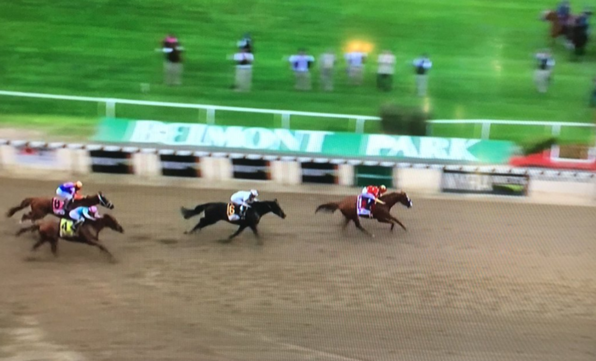 Justify races at the Belmont Stakes to capture Triple Crown.