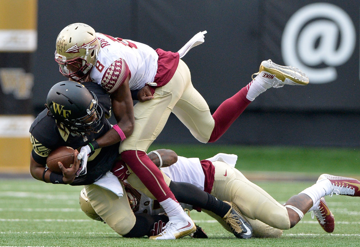 Florida State's Jalen Ramsey tackling a player.