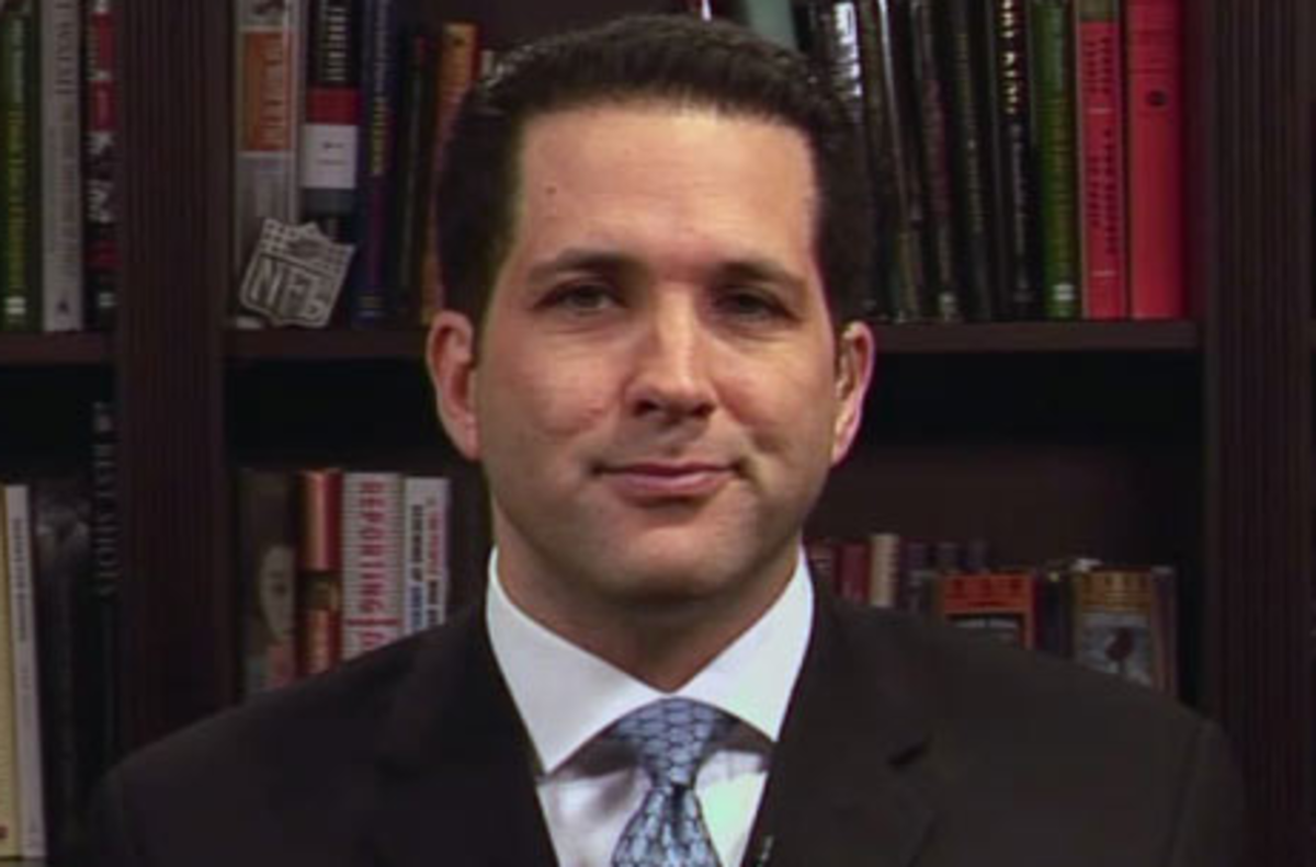 Adam Schefter sits in front of his book case during ESPN appearance.