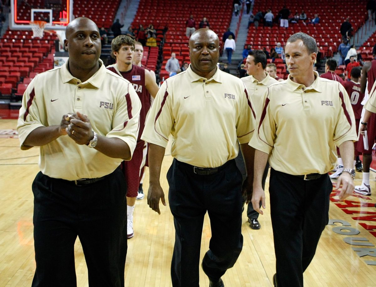Florida State basketballs coaching staff wearing gold polos.