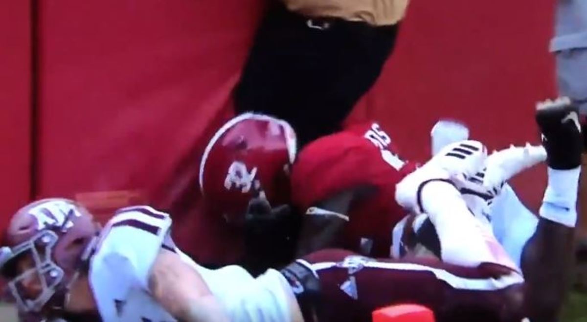 Alabama football's Dylan Moses collides with security guard out of end zone.
