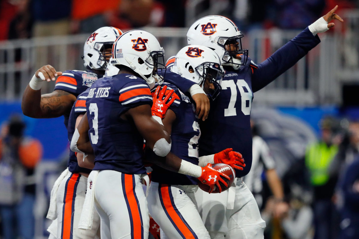 Kerryon Johnson #21 of the Auburn Tigers celebrates with teammates after scoring a touchdown in the third quarter against the UCF Knights during the Chick-fil-A Peach Bowl.