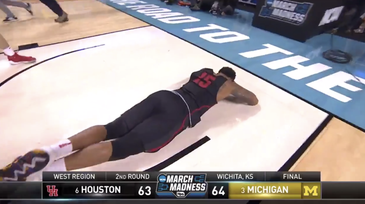 Houston player lies on the floor.