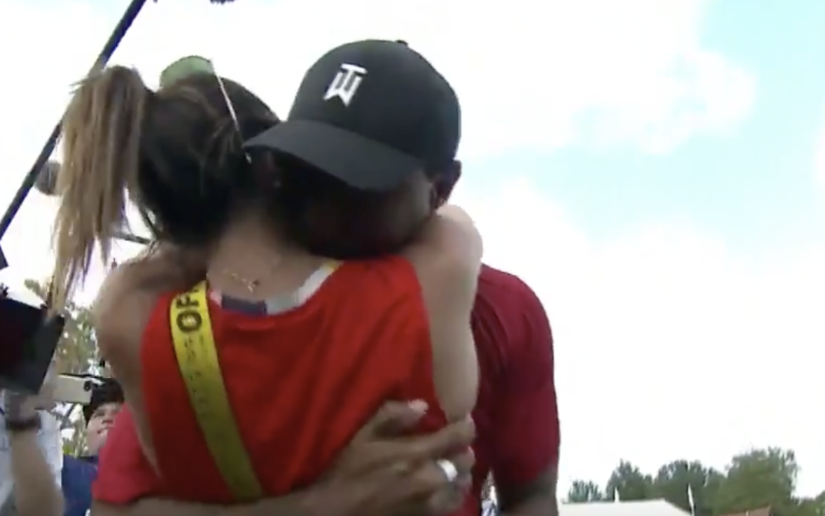 tiger woods embraced by his girlfriend