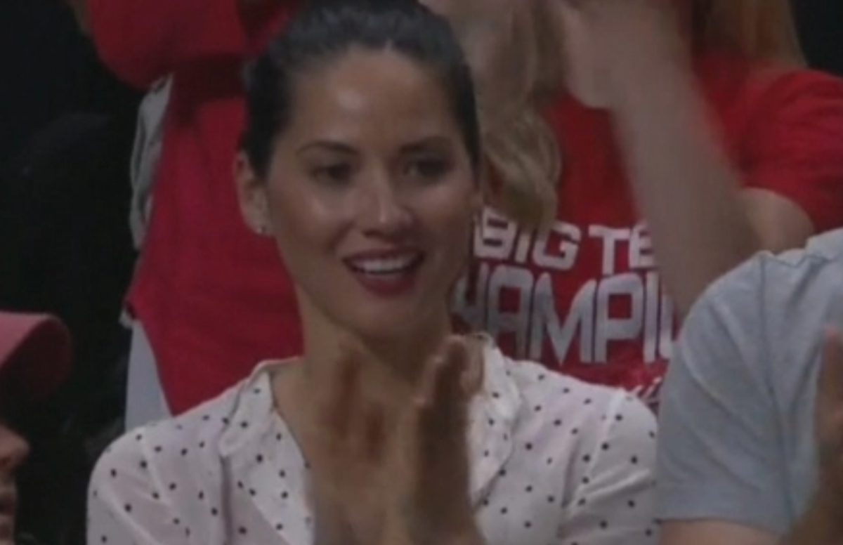 Olivia Munn clapping in the crowd.