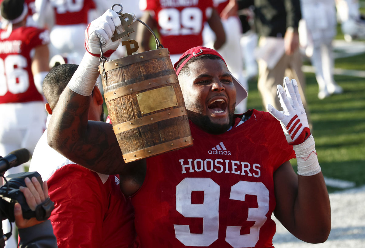 Codey Wuthrich #93 of the Indiana Hoosiers holds the Old Oaken Bucket after the game against the Purdue Boilermakers at Memorial Stadium.