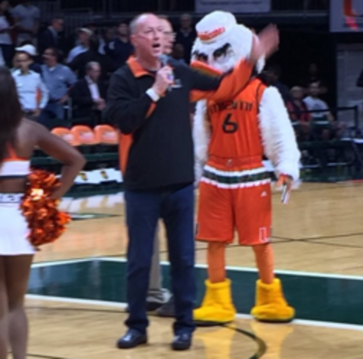 Jim Kelly gives speech at halftime of Miami basketball game.