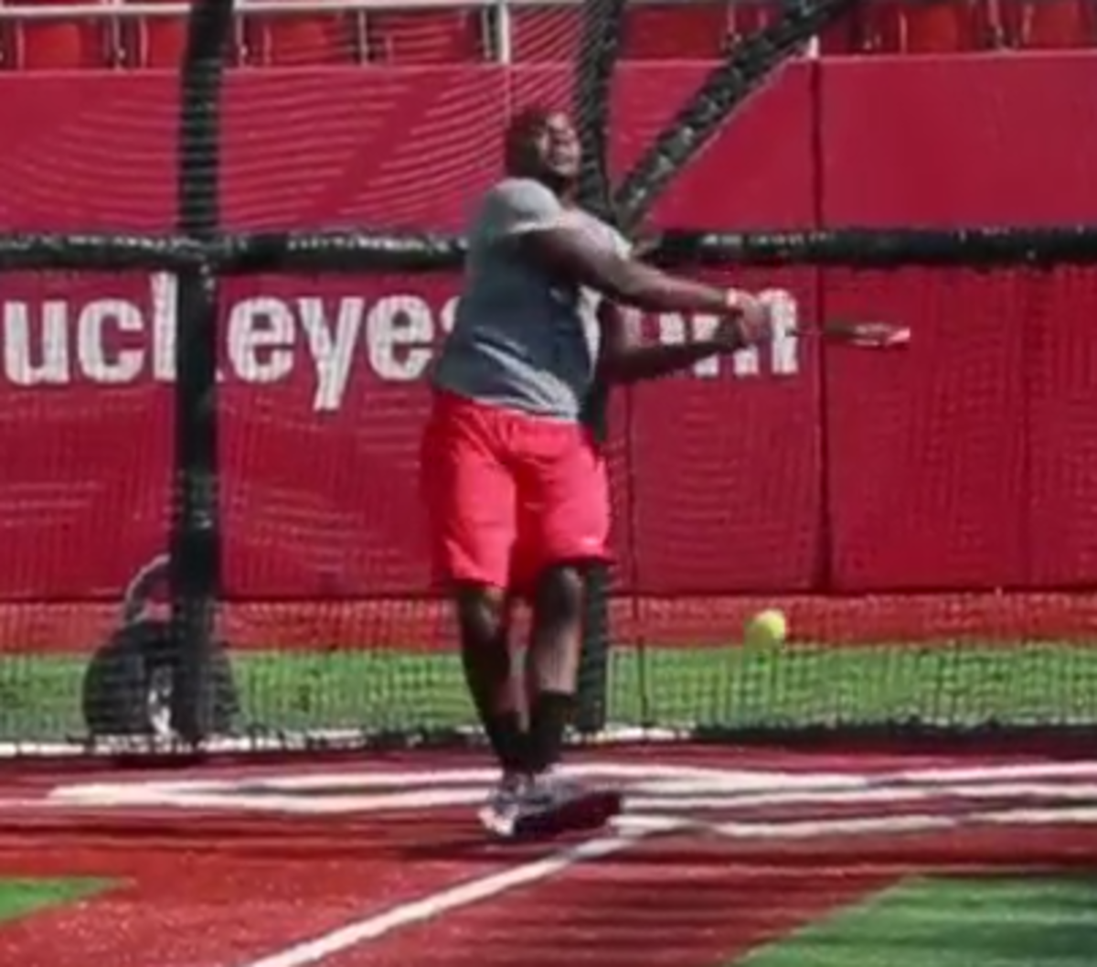 Cardale Jones swings and terribly misses a softball.