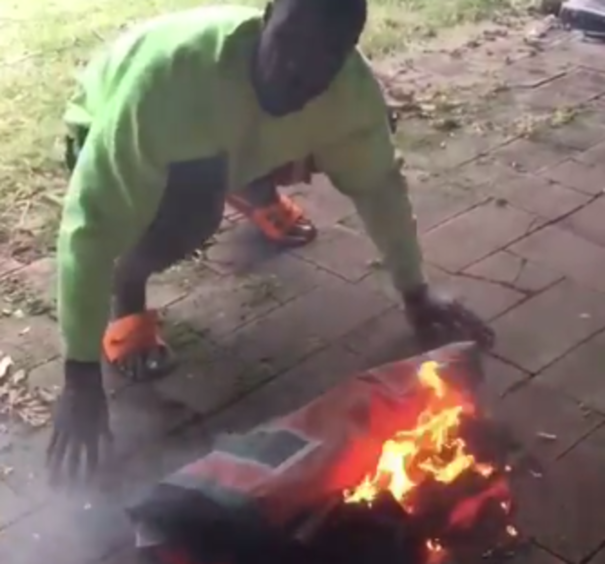 Former Miami player burns school's flag.