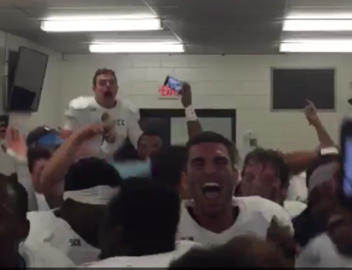 Citadel players celebrate in the locker room.