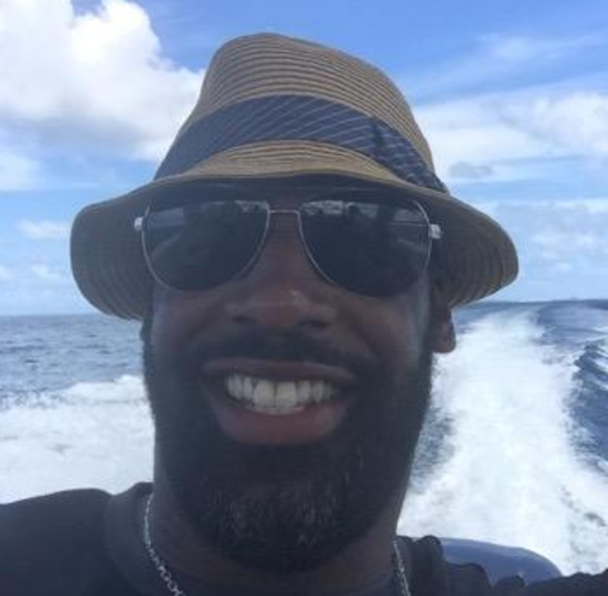 Donovan McNabb smiles while on a Boat.
